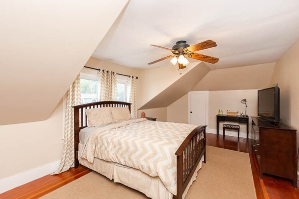 3 Spring Street Salisbury, MA 01952 - Photo 15 of 25 a spacious bedroom with a bed and a chandelier
