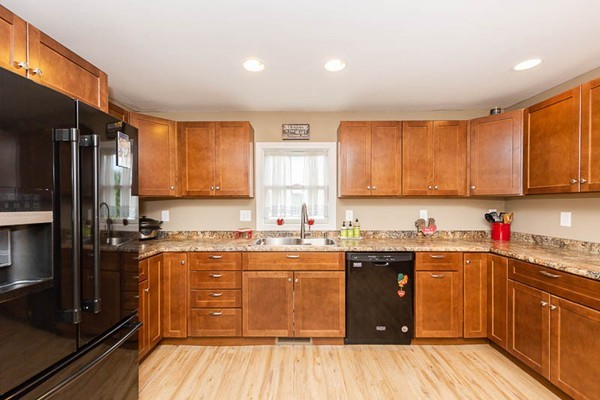 3 Spring Street Salisbury, MA 01952 - Photo 3 of 25 a kitchen with a sink a stove and cabinets