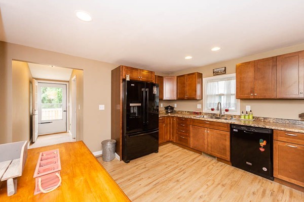 3 Spring Street Salisbury, MA 01952 - Photo 4 of 25 a kitchen with stainless steel appliances granite countertop a refrigerator and a stove top oven