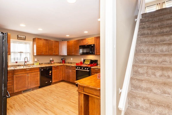 3 Spring Street Salisbury, MA 01952 - Photo 5 of 25 a kitchen with stainless steel appliances granite countertop a refrigerator sink and cabinets