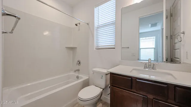 a bathroom with a sink toilet vanity and shower