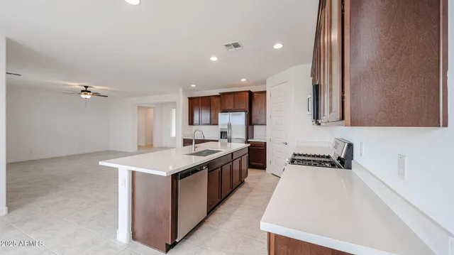 a kitchen with stainless steel appliances a sink stove and cabinets