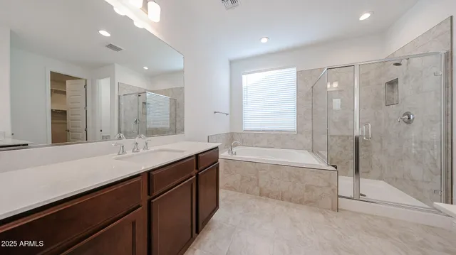 a bathroom with a granite countertop sink a toilet and bathtub
