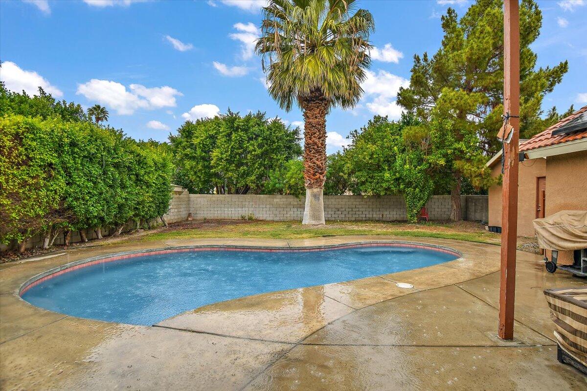 a view of swimming pool with seating space