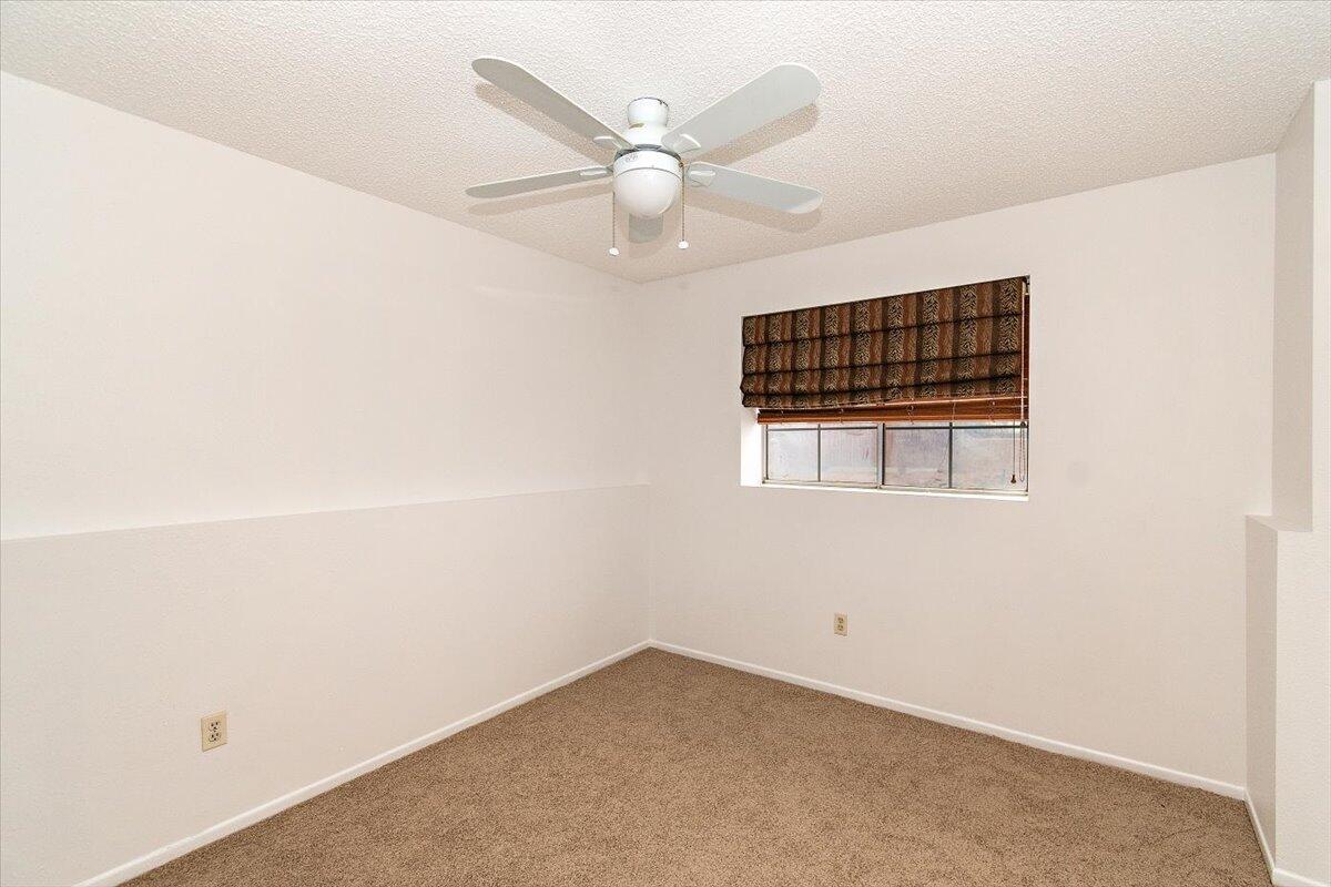 68954 Durango Road Cathedral City, CA 92234 - Photo 29 of 31 an empty room with a ceiling fan and window