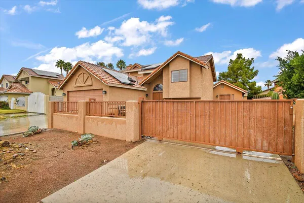 a view of a house with wooden fence