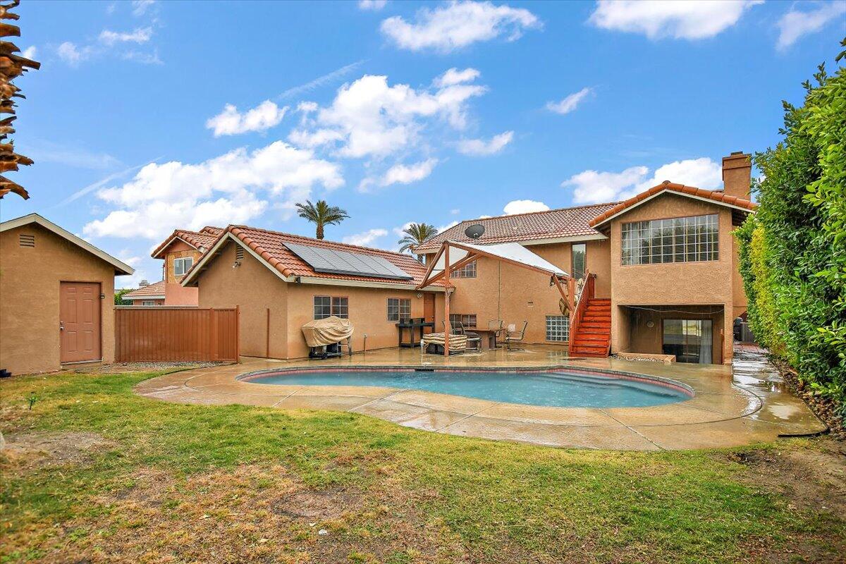 68954 Durango Road Cathedral City, CA 92234 - Photo 5 of 31 a view of a house with a big yard and large trees