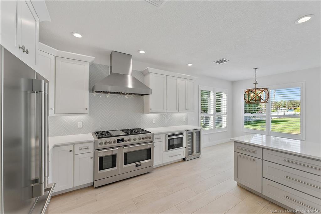 565 Southwest Yacht Basin Way Stuart, FL 34997 - Photo 12 of 55 a kitchen with stainless steel appliances a stove a sink and a refrigerator