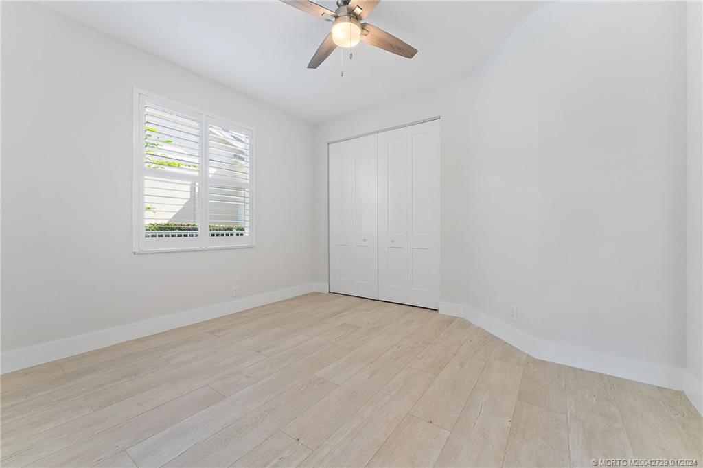 565 Southwest Yacht Basin Way Stuart, FL 34997 - Photo 18 of 55 wooden floor in an empty room with a window