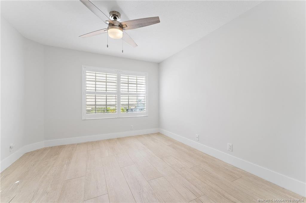 565 Southwest Yacht Basin Way Stuart, FL 34997 - Photo 22 of 55 wooden floor in an empty room with a window