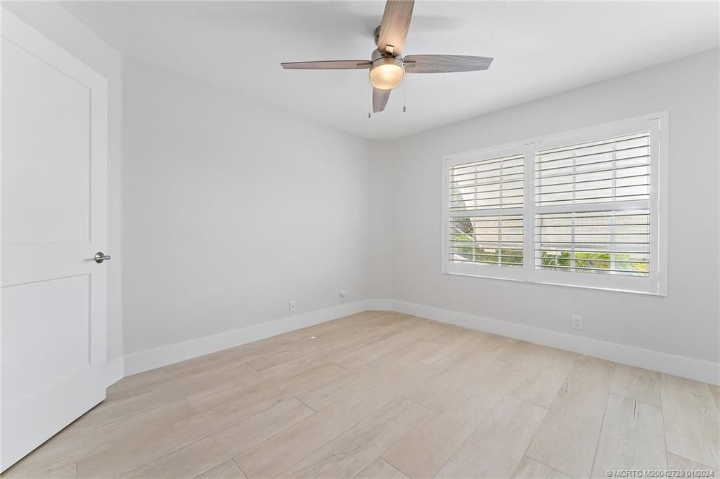 565 Southwest Yacht Basin Way Stuart, FL 34997 - Photo 23 of 55 an empty room with a window and a fan