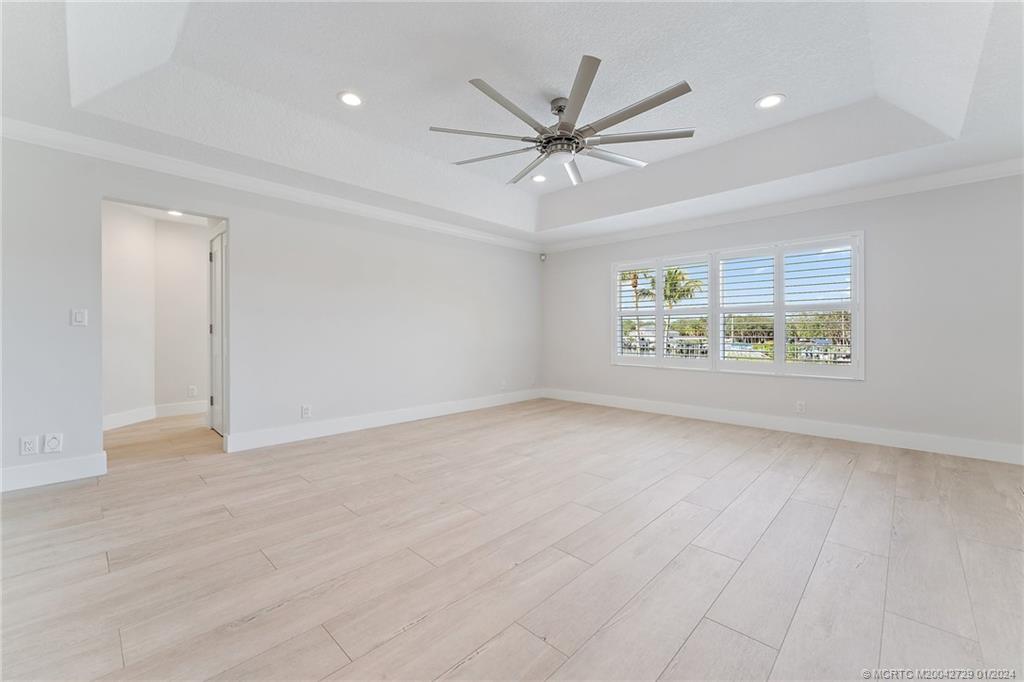 565 Southwest Yacht Basin Way Stuart, FL 34997 - Photo 24 of 55 wooden floor in an empty room with a window