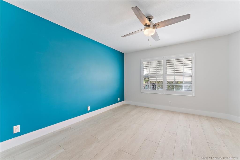 565 Southwest Yacht Basin Way Stuart, FL 34997 - Photo 36 of 55 an empty room with ceiling fan and window