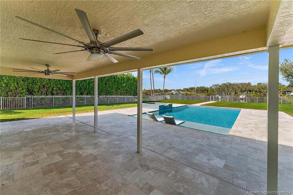 565 Southwest Yacht Basin Way Stuart, FL 34997 - Photo 38 of 55 a view of a swimming pool with a table and chairs