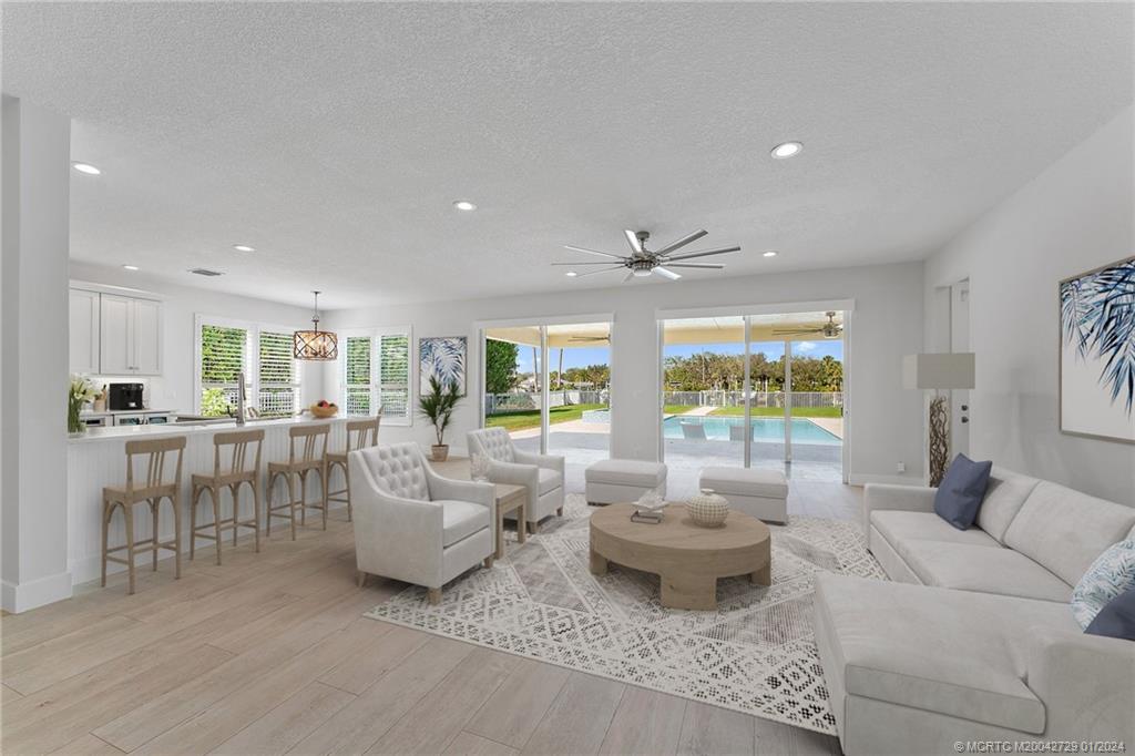565 Southwest Yacht Basin Way Stuart, FL 34997 - Photo 7 of 55 a living room with furniture and a large window