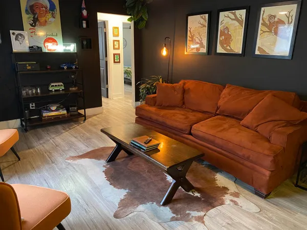 a living room with furniture and wooden floor