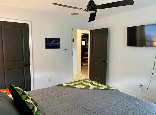 a bedroom with a bed and a flat screen tv