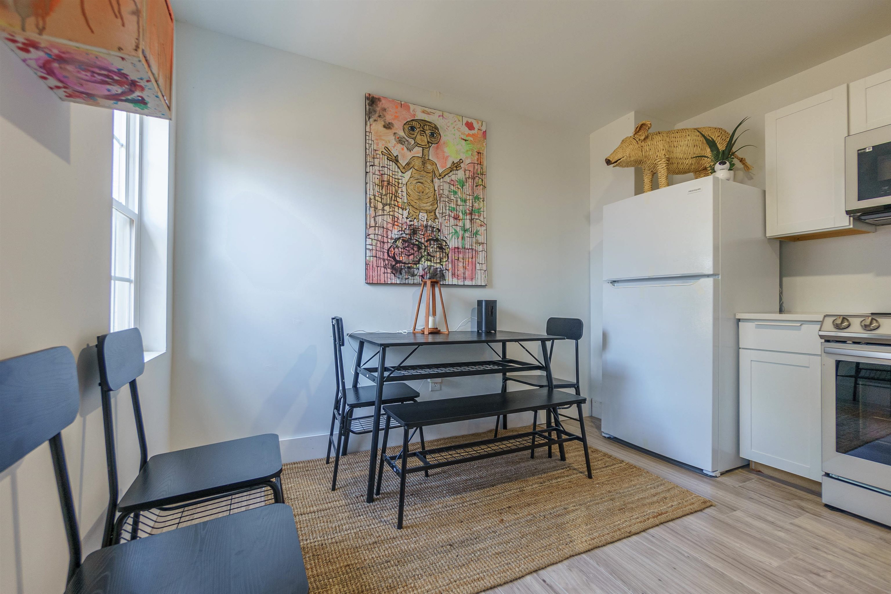84 North Holmes Street Memphis, TN 38111 - Photo 13 of 18 Kitchen featuring white cabinetry, freestanding refrigerator, stainless steel electric range, light countertops, and light wood-type flooring