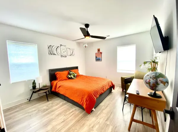 a bedroom with a bed and a flat screen tv