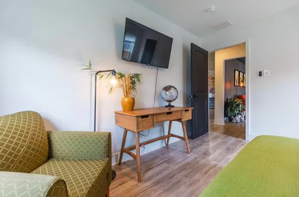 a living room with furniture and a flat screen tv