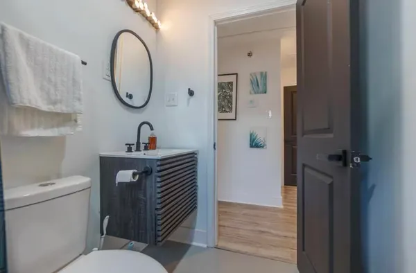 a bathroom with a toilet a sink and a mirror