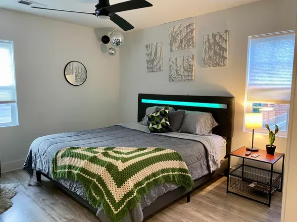 a bedroom with a bed and wall painting