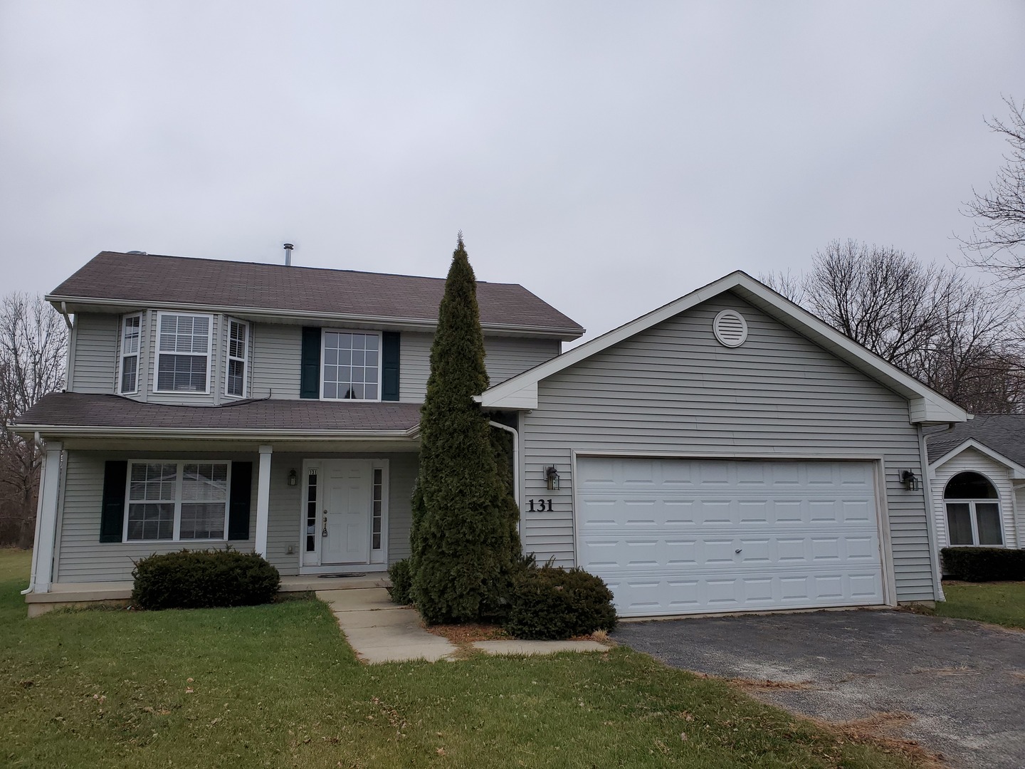 a view of a house with a yard and a large window