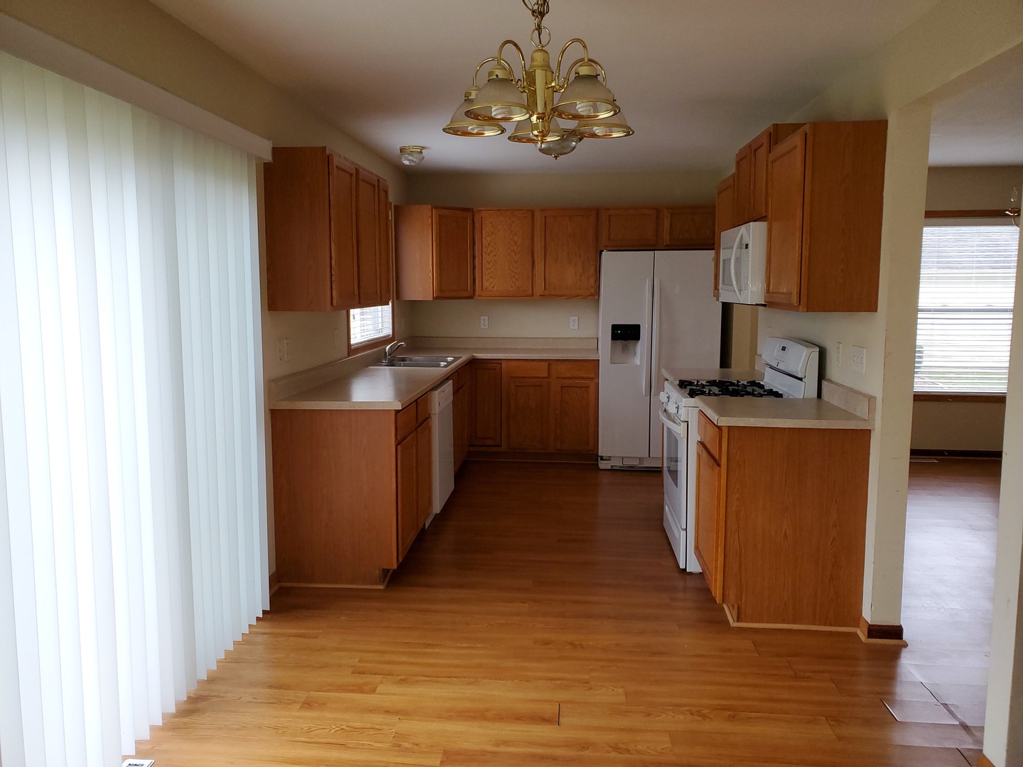 131 Lamplighter Loop Southeast Poplar Grove, IL 61065 - Photo 3 of 13 a kitchen with stainless steel appliances granite countertop a refrigerator a stove top oven a sink and dishwasher