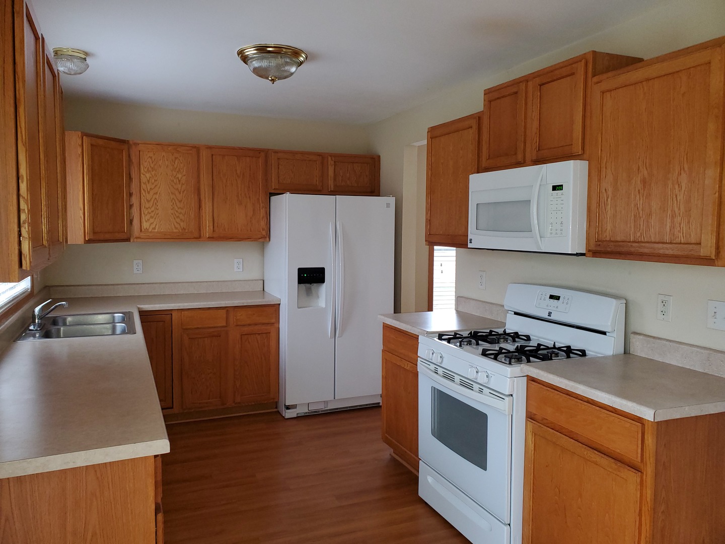 131 Lamplighter Loop Southeast Poplar Grove, IL 61065 - Photo 5 of 13 a kitchen with a appliances a sink a stove and a refrigerator