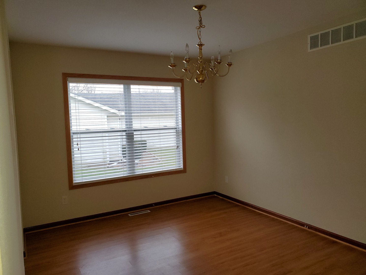 131 Lamplighter Loop Southeast Poplar Grove, IL 61065 - Photo 7 of 13 a view of an empty room with wooden floor and a window