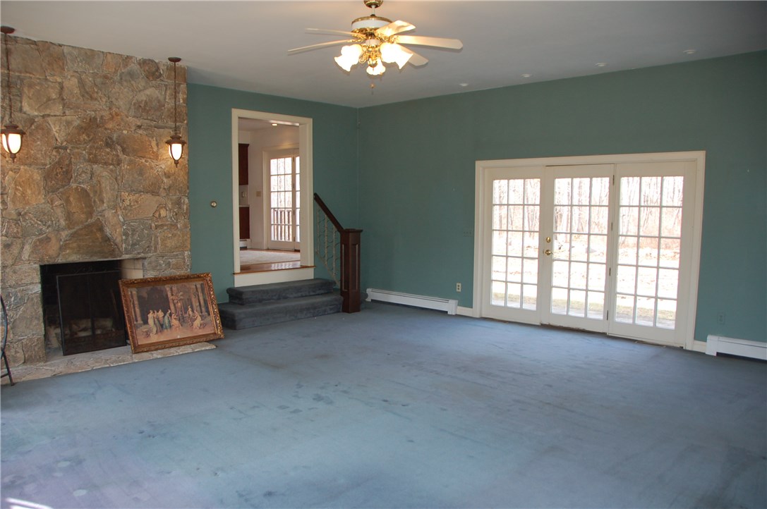 244 Klondike Road Charlestown, RI 02813 - Photo 7 of 23 Great room with stone fireplace