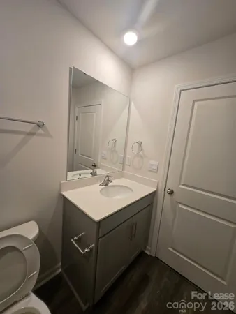 a bathroom with a sink toilet and mirror