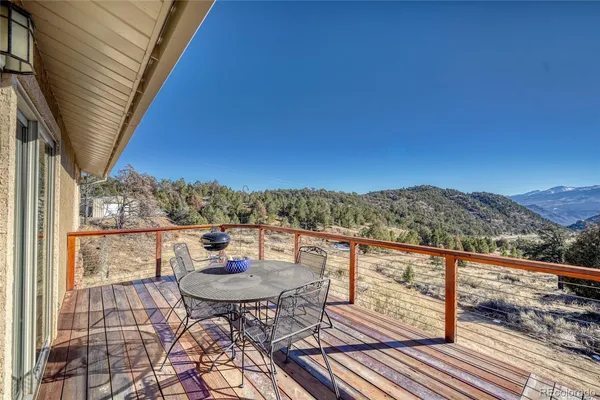 a view of a balcony with mountain view and wooden floor