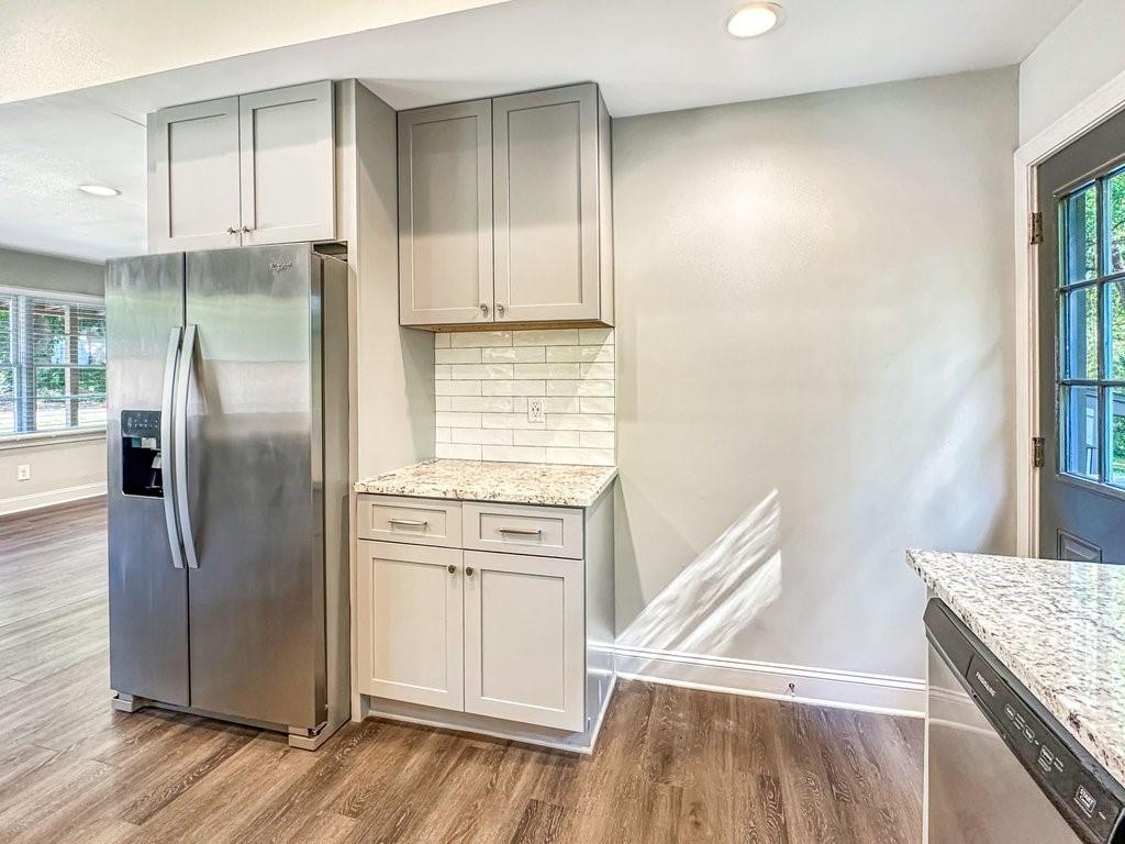 2350 Old Spring Road Smyrna, GA 30080 - Photo 12 of 26 a kitchen with white cabinets and stainless steel appliances