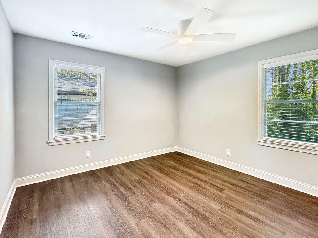 2350 Old Spring Road Smyrna, GA 30080 - Photo 17 of 26 a view of an empty room with wooden floor and a window