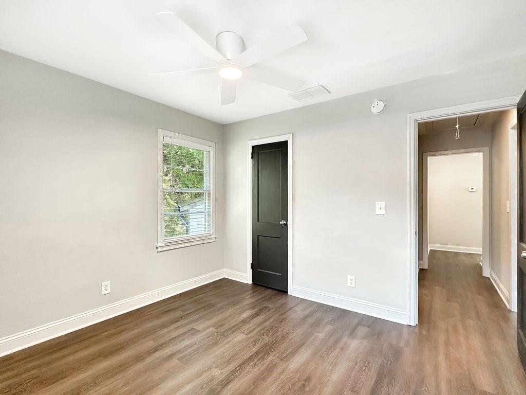 2350 Old Spring Road Smyrna, GA 30080 - Photo 18 of 26 an empty room with wooden floor and windows