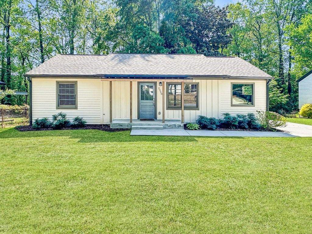 2350 Old Spring Road Smyrna, GA 30080 - Photo 2 of 26 a front view of a house with a garden