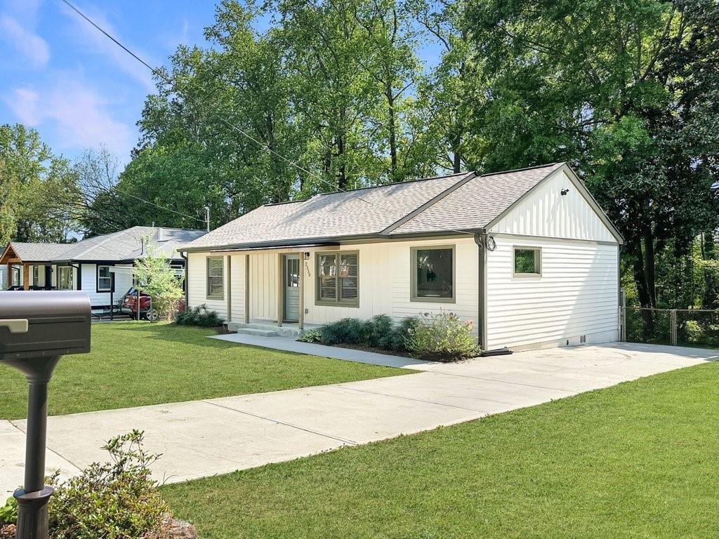 2350 Old Spring Road Smyrna, GA 30080 - Photo 3 of 26 a front view of a house with a garden and yard
