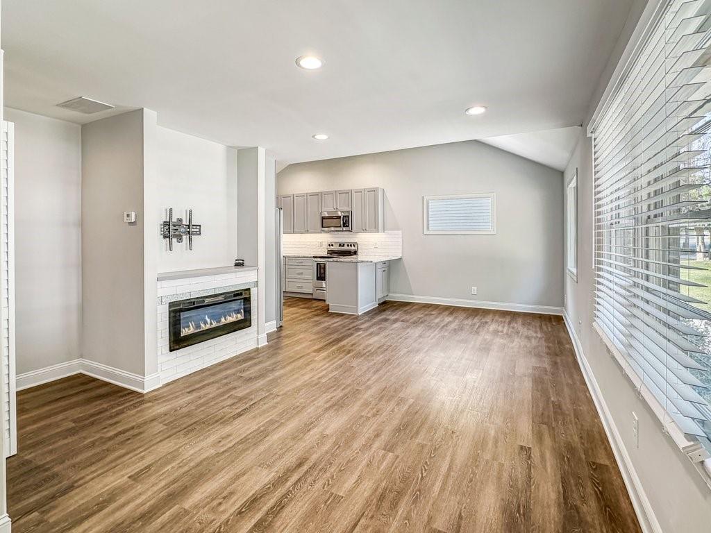 2350 Old Spring Road Smyrna, GA 30080 - Photo 6 of 26 a view of a kitchen with wooden floor electronic appliances and windows