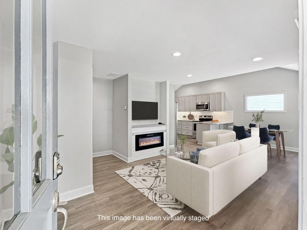 2350 Old Spring Road Smyrna, GA 30080 - Photo 7 of 26 a living room with fireplace furniture and a flat screen tv