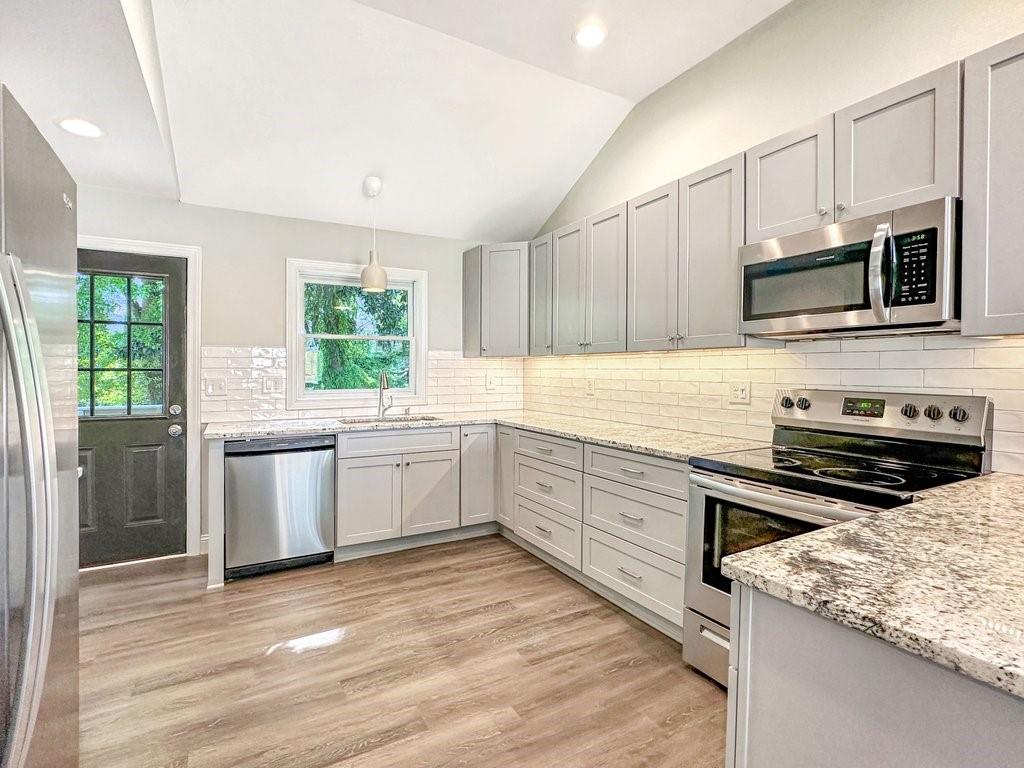 2350 Old Spring Road Smyrna, GA 30080 - Photo 10 of 26 a kitchen with stainless steel appliances kitchen island granite countertop a stove sink and microwave