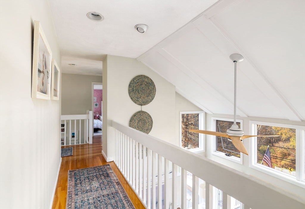 255 Elm Street Marshfield, MA 02050 - Photo 17 of 42 a view of a hallway to a dining room with chandelier fan and windows