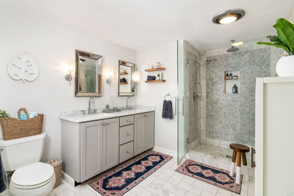 255 Elm Street Marshfield, MA 02050 - Photo 21 of 42 a bathroom with a sink a toilet a mirror and shower