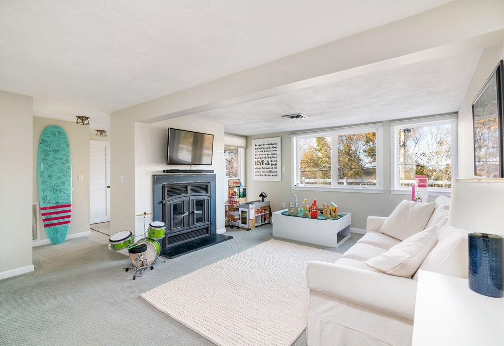 255 Elm Street Marshfield, MA 02050 - Photo 25 of 42 a living room with furniture a fireplace and a flat screen tv