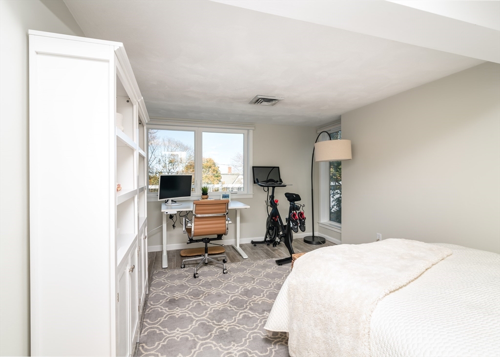 255 Elm Street Marshfield, MA 02050 - Photo 27 of 42 a bedroom with a bed and a desk