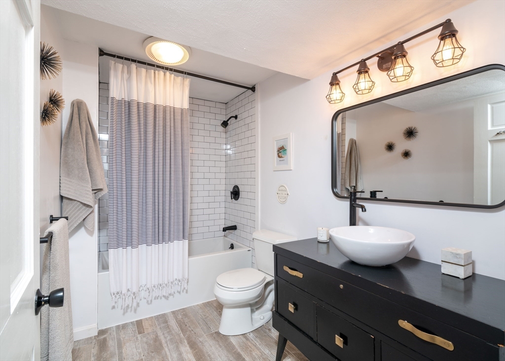 255 Elm Street Marshfield, MA 02050 - Photo 28 of 42 a bathroom with a toilet sink and mirror