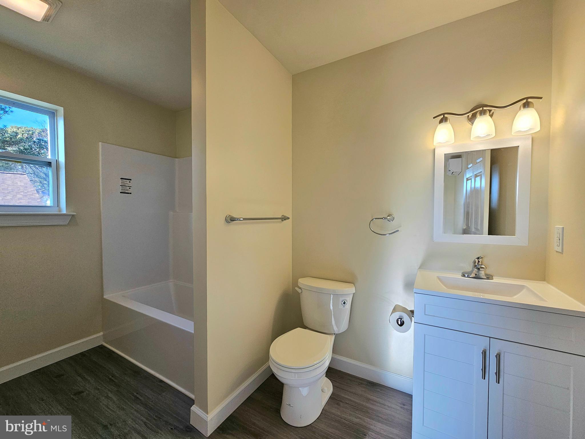 26404 Franklin Road Crisfield, MD 21817 - Photo 12 of 31 a bathroom with a toilet sink and mirror