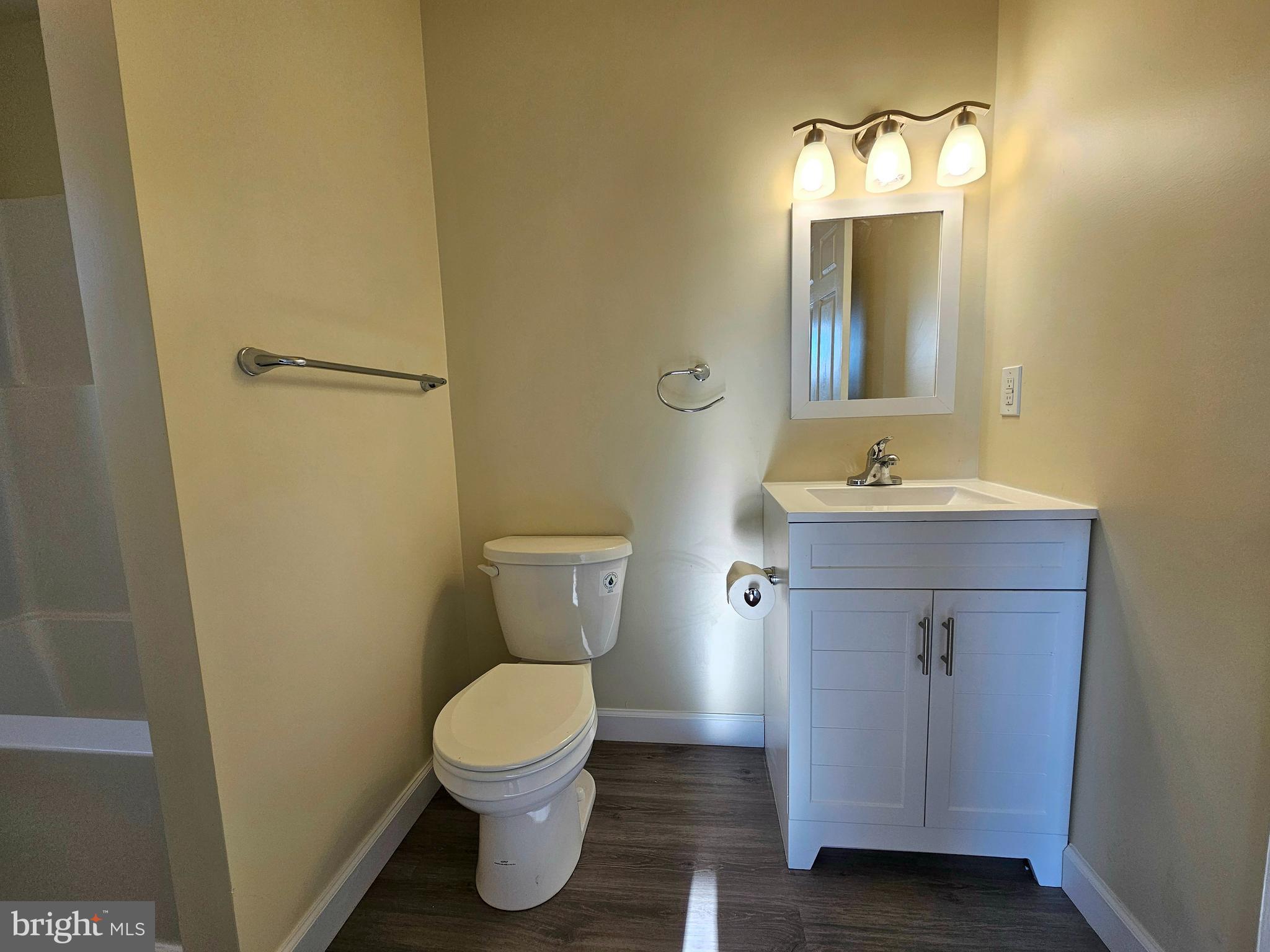 26404 Franklin Road Crisfield, MD 21817 - Photo 13 of 31 a bathroom with a toilet sink and mirror