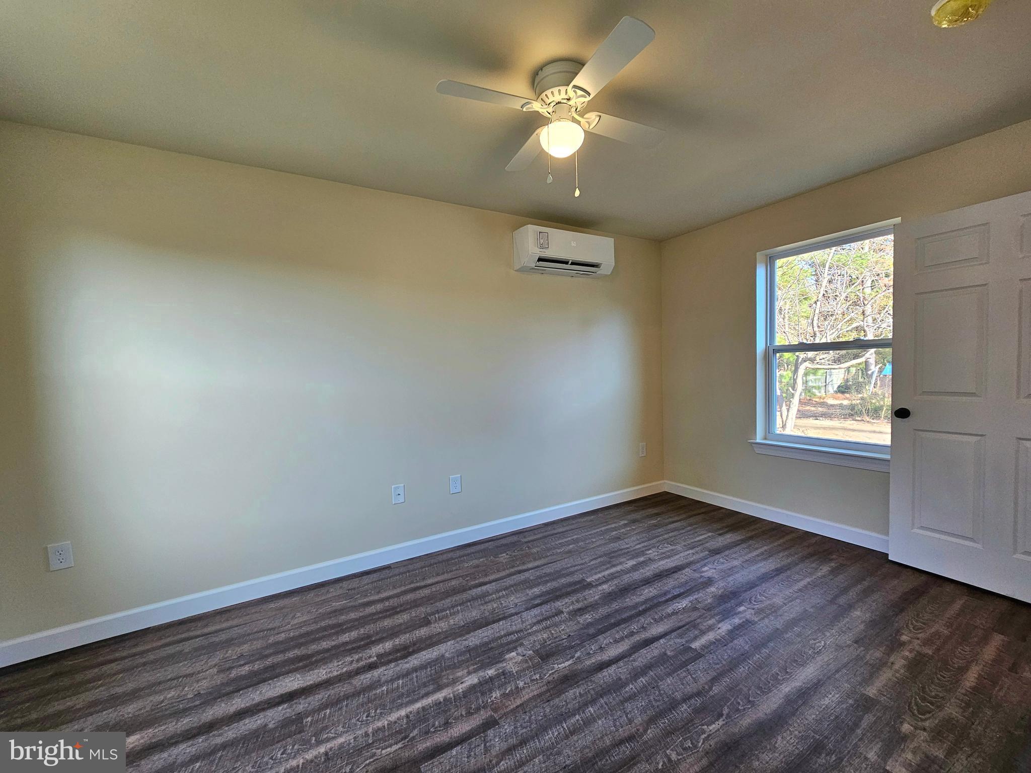 26404 Franklin Road Crisfield, MD 21817 - Photo 24 of 31 an empty room with wooden floor ceiling fan and windows