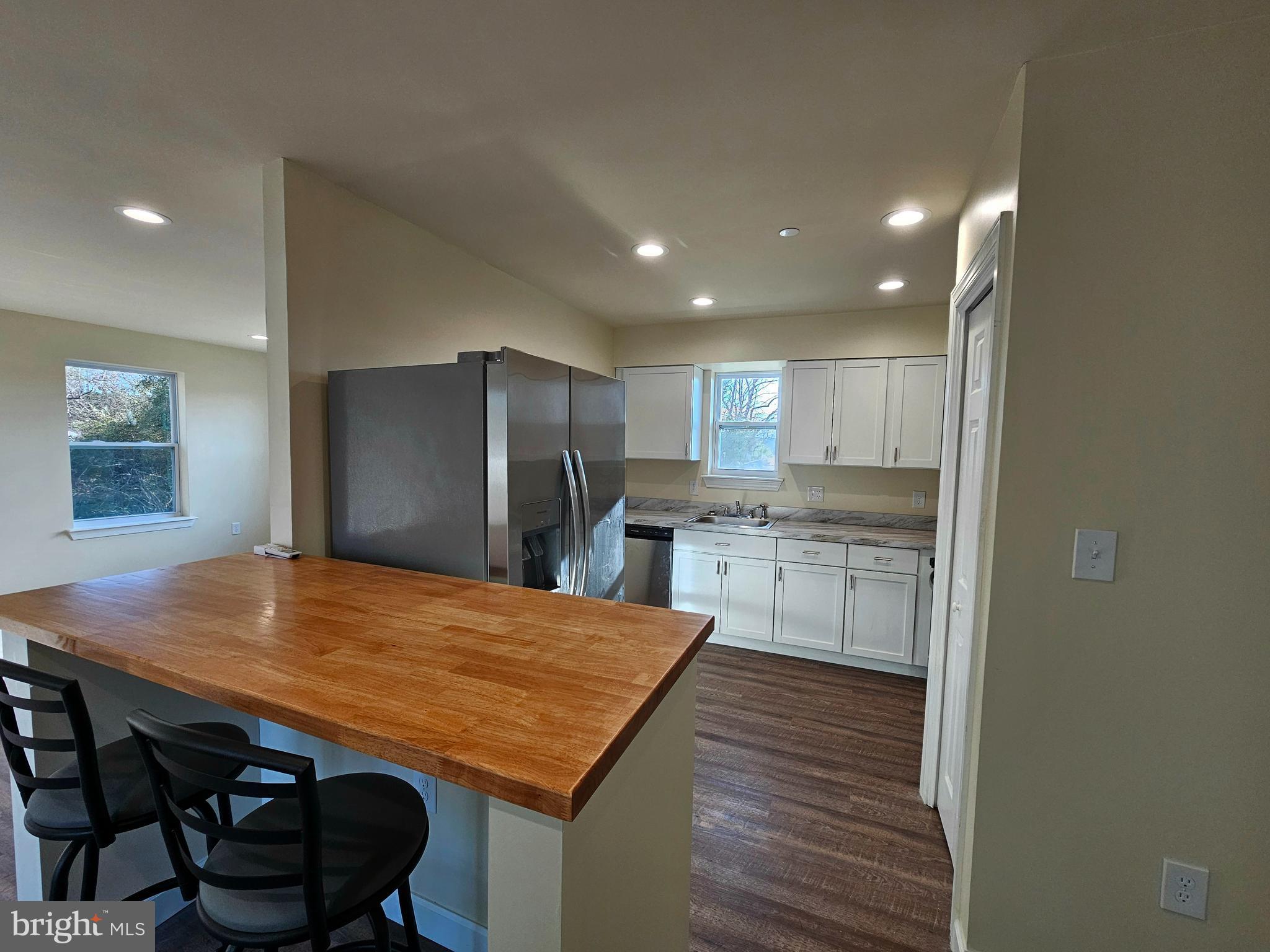 26404 Franklin Road Crisfield, MD 21817 - Photo 5 of 31 a kitchen with stainless steel appliances granite countertop a kitchen island a stove and a refrigerator
